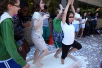 Middle school student dance and try yoga stands in the water and corn starch mix without sinking into it outside of the GG Brown building on U-M North Campus.