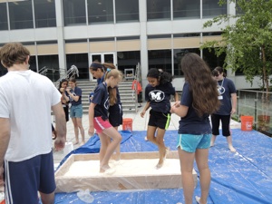Many campers standing on top of the Oobleck pool.