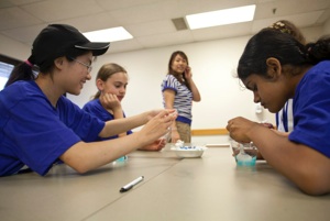 Student oversees campers eat "dino eggs."